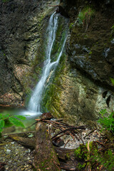 Obraz premium A small waterfall on the hiking trail in the Slovak Paradise National Park