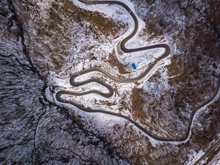 Winter aerial top view of the road to ski resort Krasnaya Polyana. Beautiful winter landscape from drone.