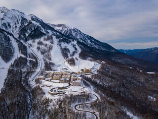 Aerial view to ski resort Krasnaya Polyana (ex. Gorki Gorod). Beautiful winter landscape from drone.