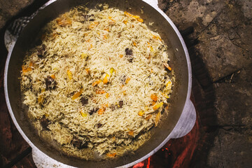 pilaf in a cauldron on bonfire