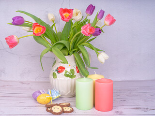Bouquet of flowers. Tulips close-up. Various colors. Easter eggs, candles. Postcard, Spring and Happy Easter