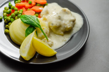 Cod Mornay, flaky cod with a creamy cheese sauce, with mashed potato, peas and carrots