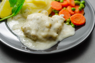 Cod Mornay, flaky cod with a creamy cheese sauce, with mashed potato, peas and carrots
