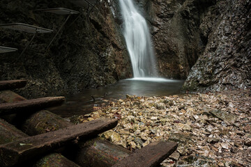 Difficul trail with ladder near the waterfall in canyon of National park Slovak paradise, Slovakia.