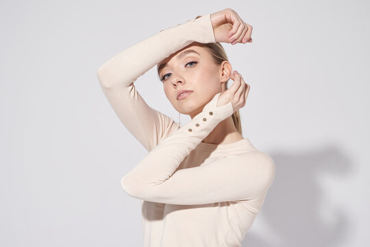 Pretty model in beige blouse and jeans. Glow makeup, healthy skin and so natural.