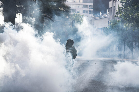 Riot Police Amid Tear Gas