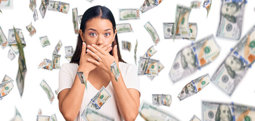 Young beautiful latin girl wearing casual white t shirt shocked covering mouth with hands for...