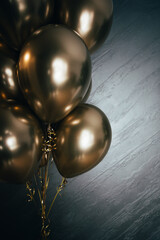 Festive and elegant background with silver wall and golden balloons.