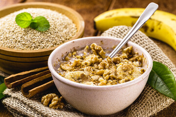 walnuts, cinnamon and banana porridge in a recycled plastic bowl