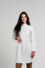 Girl surgeon in medical dress with curly hair on white background. 3rd wave of coronavirus covid-19 epidemy.