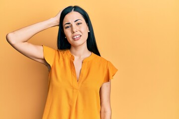 Beautiful young woman wearing casual clothes confuse and wonder about question. uncertain with...