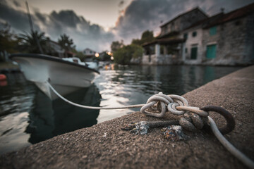 Boat tied by rope on the dock