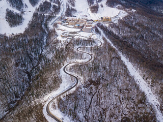 Aerial view to ski resort Krasnaya Polyana (ex. Gorki Gorod). Beautiful winter landscape from drone.