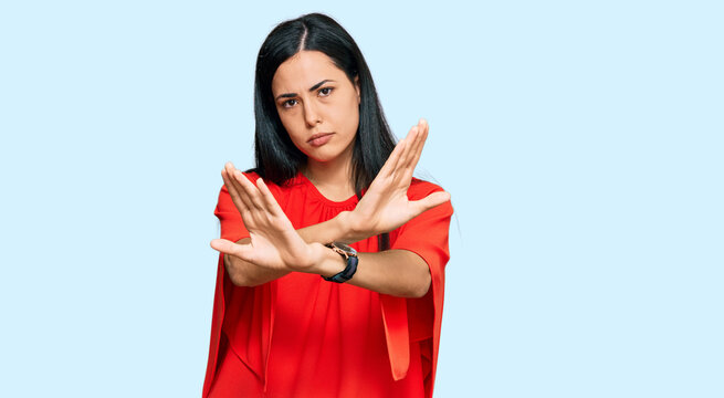 Beautiful young woman wearing casual clothes rejection expression crossing arms doing negative sign, angry face