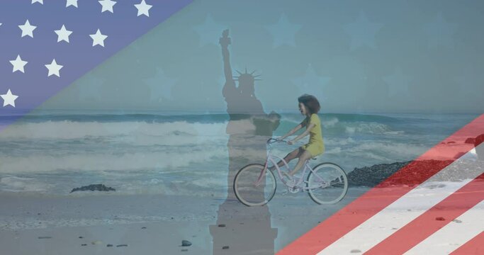 Animation of american flag revealing statue of liberty and woman riding bike on beach