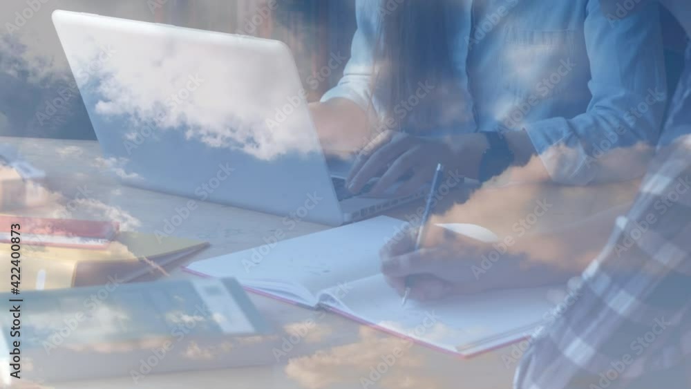Aufkleber animation of people working using laptop and writing over clouds in background