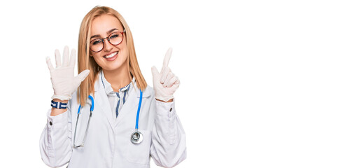 Beautiful caucasian woman wearing doctor uniform and stethoscope showing and pointing up with...