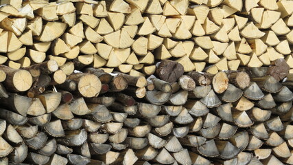 Old and new  woodpile for fire, grey and beige