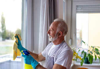 Senior man cleaning windows