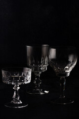 A variety of crystal glasses on dark background.