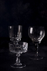 Clear crystal glass filled with golden liquor on dark background.