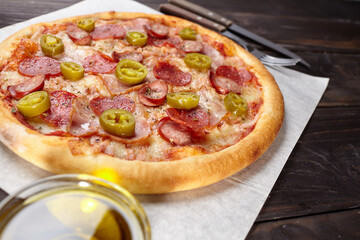 tasty pizza on the wooden background