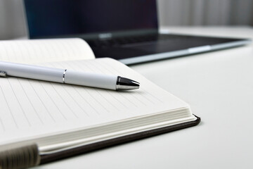 Pen on notebook in composition with silver toning.