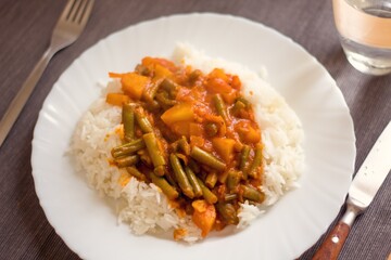homemade aloo gobi with rice served on a white plate during isolation at home