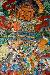 Fototapeta premium Colorful mural of a guardian deity at Songzanlin Tibetan Buddhist monastery, Shangri-la, Yunnan Province, China