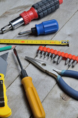 some home repair tools lie on a wooden background. close-up.