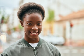 Young african american girl smiling happy standing at the city.