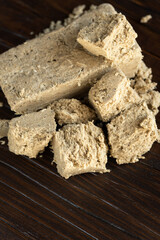 Delicious oriental dessert sunflower halva on a dark background.