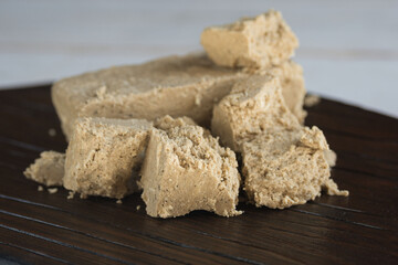 Delicious oriental dessert sunflower halva on a dark background.