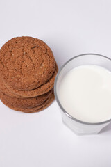 oat cookies with a glass of milk isolated on white background