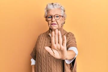 Senior grey-haired woman wearing casual clothes and glasses doing stop sing with palm of the hand. warning expression with negative and serious gesture on the face. - obrazy, fototapety, plakaty