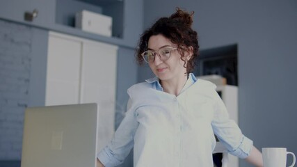 Positive successful woman freelancer stretching working laptop, coffee break