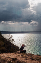 Fototapeta na wymiar Woman looking at scenic view of Lake Baikal