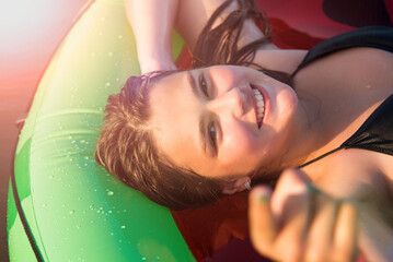 Happy teenage girl floating with watermelon lilos, sea - having fun swimming in summer vacation -...