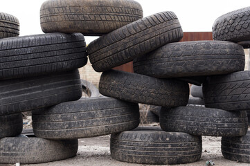 A wall of spoiled wheels. Fencing made of old tires for car wheels. Dump of wheels.