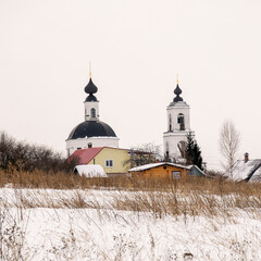 landscape with a rural orthodox church in winter