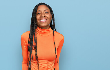 African american woman wearing casual clothes looking positive and happy standing and smiling with...