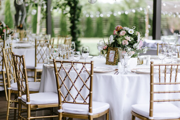The close-up of a composition of flowers and candles for a wedding decoration of tables for guests