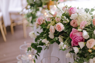 Close-up of a composition of white and pink flowers for a wedding table decoration of the newlyweds