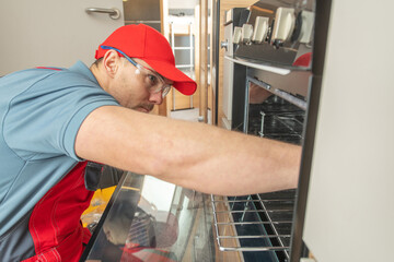 RV Technician Replacing Broken Recreational Vehicle Stove