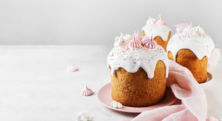 Traditional Russian Easter Cake with Marshmallow, Sweet Filling, with Icing and confectionery sprinkles as Decoration on pink plate. Light Easter-Orthodox holiday background.Banner.