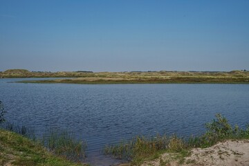 Fototapeta na wymiar lake Taneso, Borsmose, Vejers, Jutland, Denmark on sunny day with blue sky
