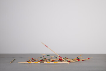 mikado game sticks, fallen down on a wooden board, motion blur