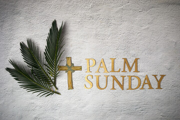 Palm sunday background. Cross and palm on grey background.