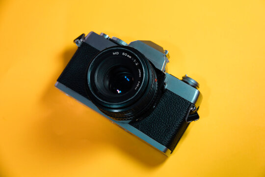 old vintage hipster camera in a color background