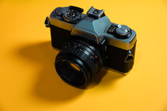 old vintage hipster camera in a color background 